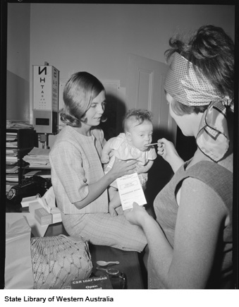 A baby is given the new Sabin polio vaccine in sugar.